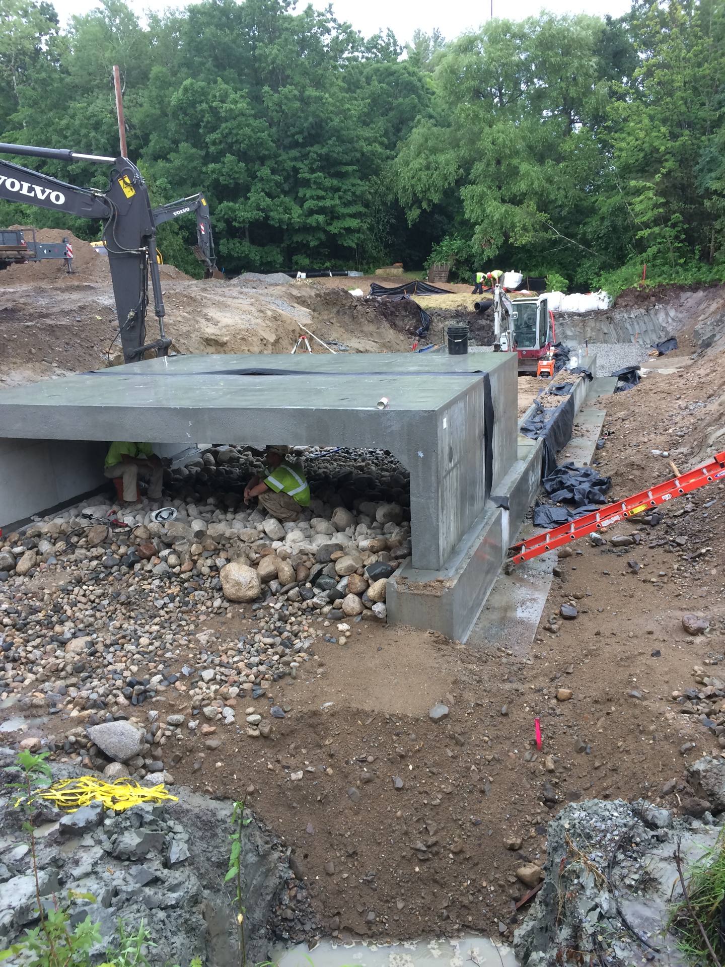Precast box culvert set in Saco with headwall, wingwalls, and the simulated cobble streambed through the barrel